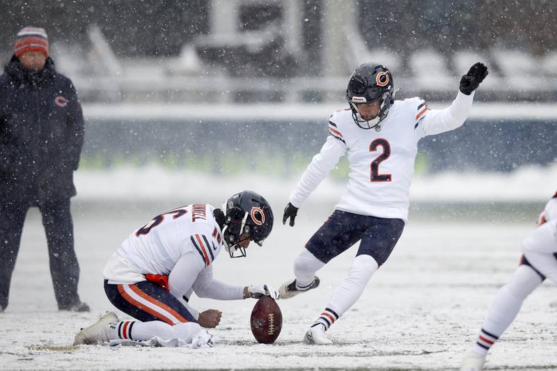Chicago Bears kicker Cairo Santos practices with Pat O'Donnell holding in the snow before playing the Seattle Seahawks on Sunday, Dec. 26, 2021, in Seattle.