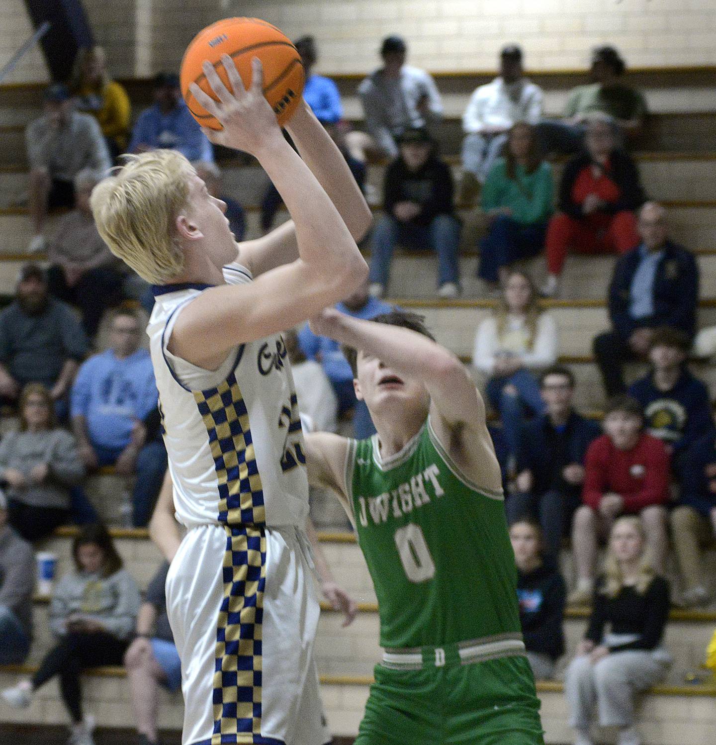 Marquette’s Luke McCullough shoots over the block attempt of Dwight’s Owen Dunlap in the 2nd period Monday at Marquette.
