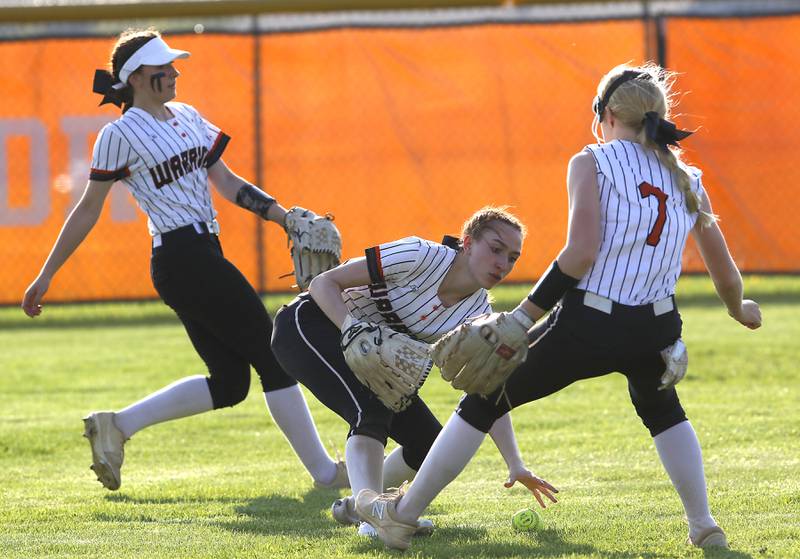McHenry's Gianna Buske center grabs the ball in between her teammates, Vaness Buske, left, and McHenry's Maddie Gillund,  right, during a Fox Valley Conference softball game Monday, May 9, 2022, between McHenry and Crystal Lake South at McHenry High School.