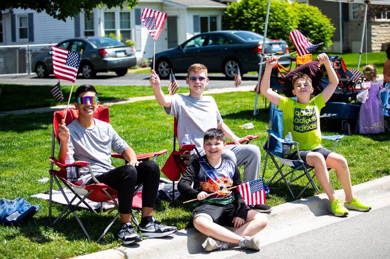 (L:R) New Lenox residents Ben Morales, Jackson Hurley, Kyle Kladis, and Ryan Hiznay wave the American flag during the New Lenox Loyalty Day Parade on May 5, 2024. (Laurie Fanelli for Shaw Local News Network)