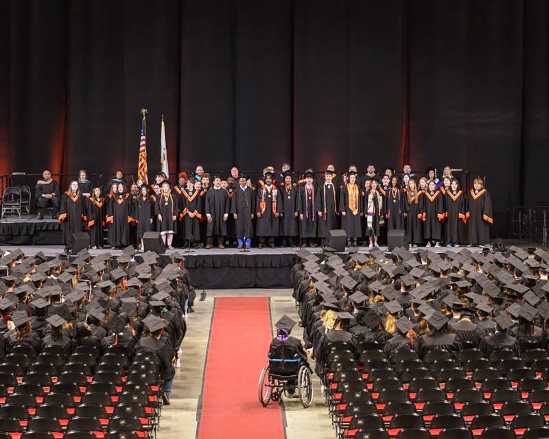 The DeKalb High School choir sings on Saturday, May 24, 2025, during the Class of 2025 Commencement ceremony held at the NIU Convocation Center in DeKalb.