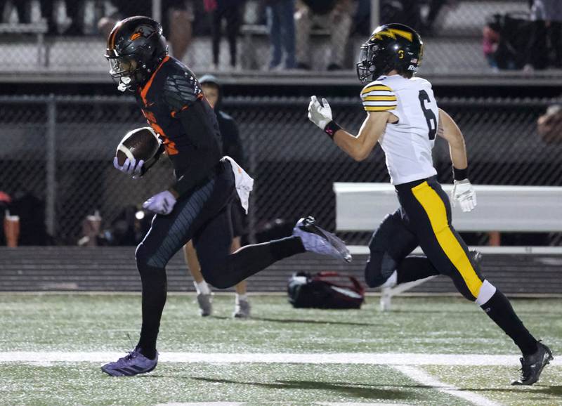 DeKalb's Davon Grant is off to the endzone ahead of Andrew’s Connor Vrastil after catching a pass during their game Friday, Oct. 16, 2025, at DeKalb High School.
