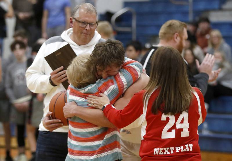 Marian Central’s Christian Bentancur hugs his grandmother, Donna Dziuba, after scoring his 2,000 point as his father, Patrick, and mother, Elizabeth, watch during a nononference boys basketball game against Marengo on Tuesday, Feb.13, 2024, at Marian Central High School.