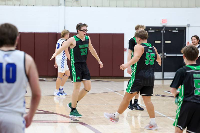 Bishop McNamara's Callaghan O'Connor high fives teammate Ian Irps during the Fightin' Irish's 62-41 victory over Clifton Central in the Watseka Holiday Tournament championship on Tuesday, Dec. 16, 2025.