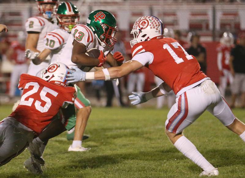 L-P's Reggie Boatner runs the ball as Ottawa's Michael McGill and teammate Owen Sanders bring him down on Friday, Sept. 12, 2025 at King Field.
