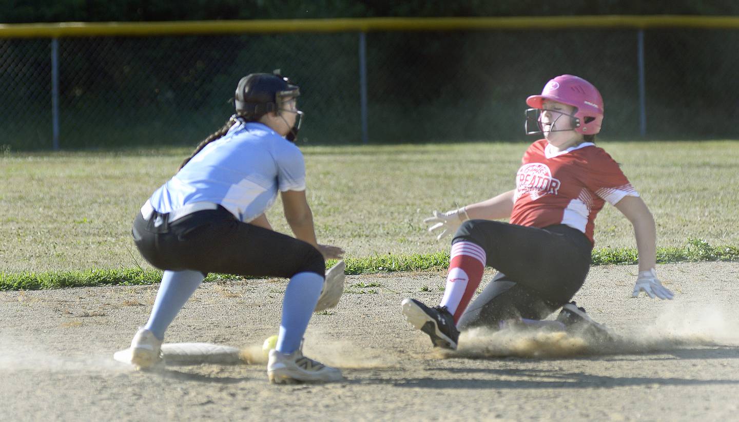 Dairy Queen runner Scarlett Lesak slides into second base with a stolen base while MJ Track Works shortstop Priscilla Arevalo awaits the tag during Wednesday's Streator Girls Softball 14U city title game at Bodznick Park in Streator.