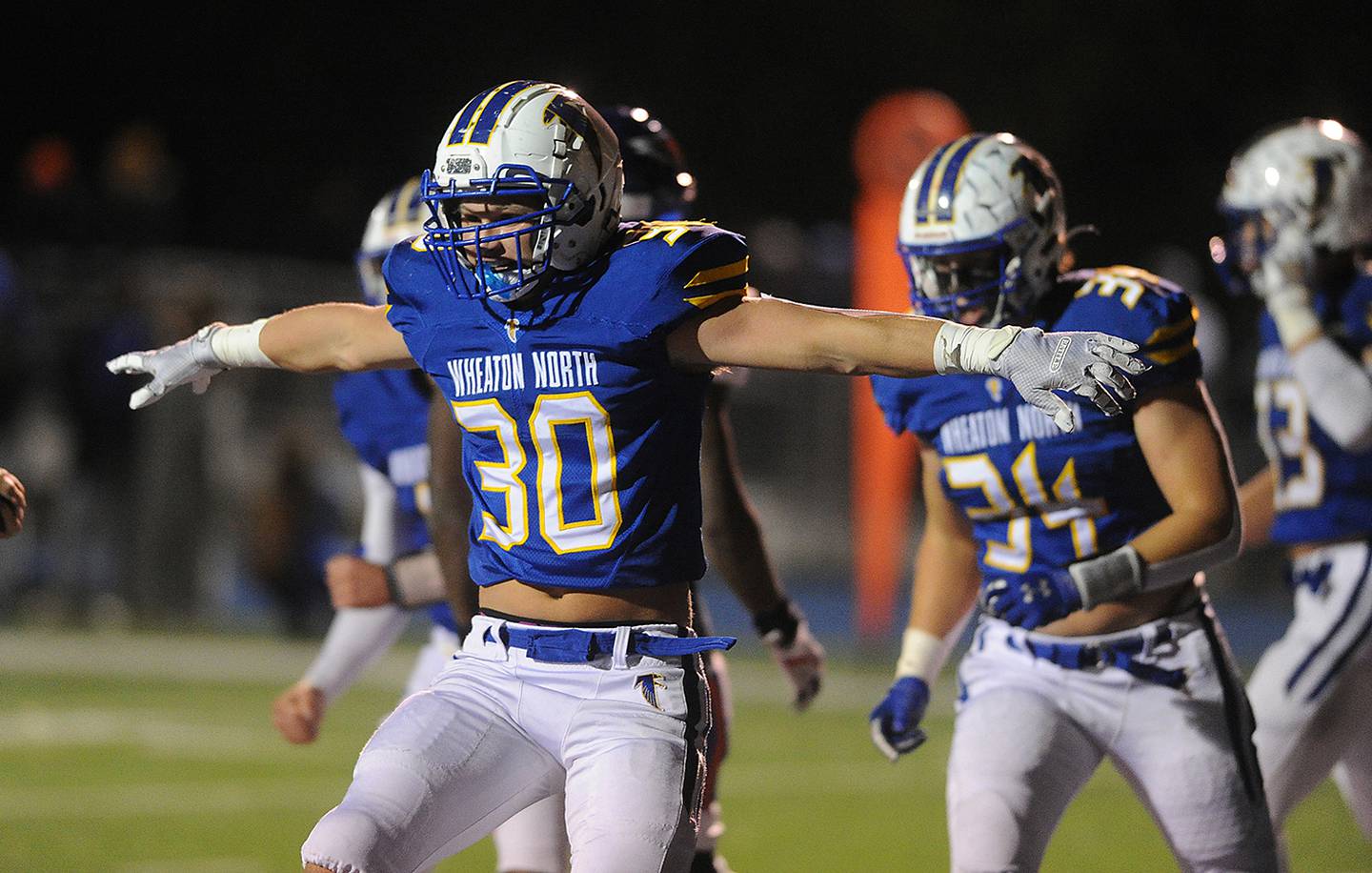 Wheaton North's Luke Beedle celebrates his second  touchdown of the first half against Hoffman Estates in the boys Class 7A football playoff game in Wheaton on Friday.