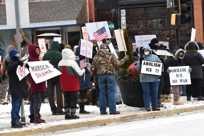 Attendees at an Indivisible of Ogle County protest against ICE show their signs as they stand along state Route 2 in downtown Oregon on Sunday, Jan. 25, 2026. Signs criticized the Trump administration's deployment of ICE officers to several states and the shooting death of Alex Pretti by ICE agents on Saturday in Minneapolis.