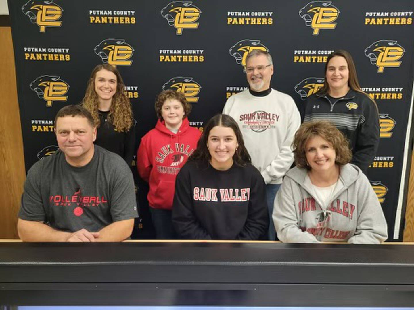 Putnam County senior Maggie Richetta (front center) signs to play volleyball for Sauk Valley College. She was joined at her signing by (front) her parents, Mike and Melissa Richetta; and (back) PC head coach Amy Bell, her bother, Stevie, Sauk Valley coach Jay Howell, and PC assistant coach Shannon Jenkins. Richetta was named as the NewsTribune's Player of the Year.