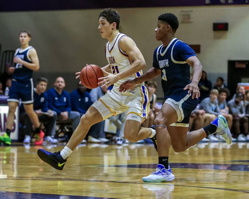 Downers Grove North's Jack Stanton (21) drives down the lane during basketball game between Downers Grove South at Downers Grove North. Dec 16, 2023.