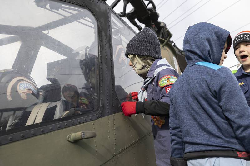 Colton Shroyer (left), 8, Asher Gilbert, 7, and Samuel Gilbert, 9, check out the warship on display Tuesday, Nov. 11, 2025, at Veterans Memorial Park in Dixon. The boys were attending a Veterans Day ceremony with their Scout troop.