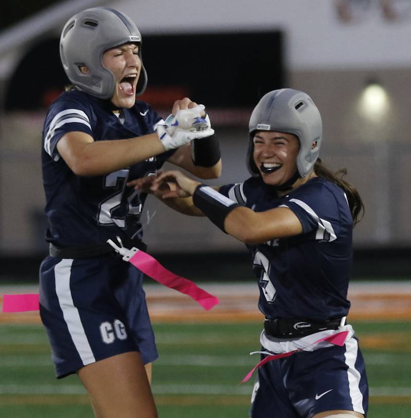 Cary-Grove's Aria Stanton and  Kennedy Manning celebrate they win over McHenry in  the IHSA McHenry Regional girls flag football championship game on Wednesday, Oct. 8, 2025, at McCracken Field in McHenry.