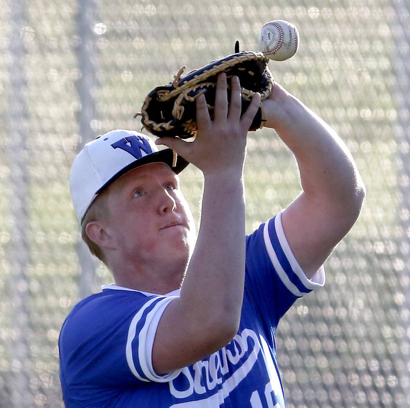 Woodstock North’s Shane Buening tries to catch a foul ball during a Kishwaukee River Conference baseball game against Woodstock North Tuesday, April 18, 2023, at Emricson Park.
