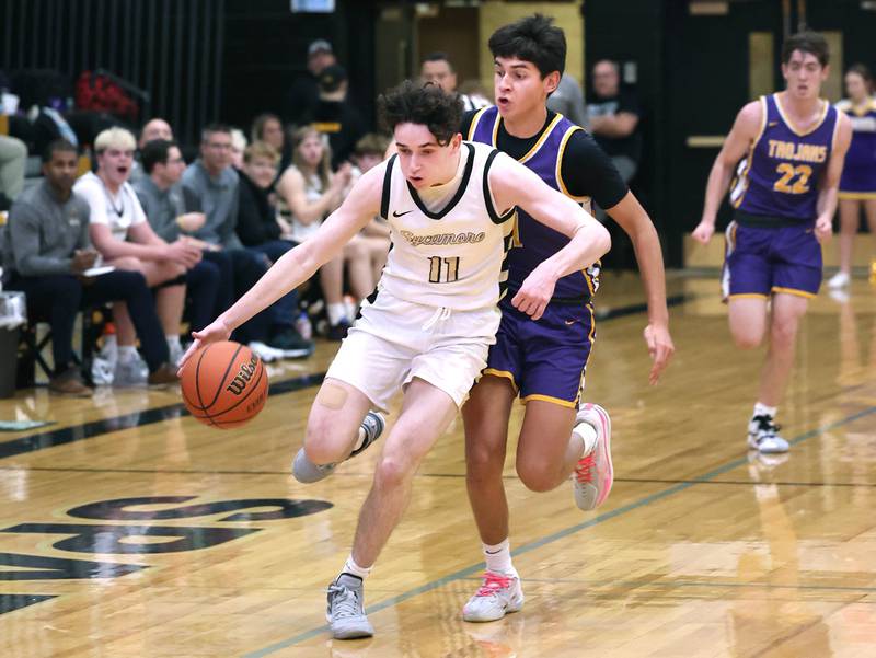 Sycamore's Jake Shipley pushes the ball ahead of Mendota’s Izaiah Nanez during their game Wednesday, Dec. 13, 2023, at Sycamore High School.