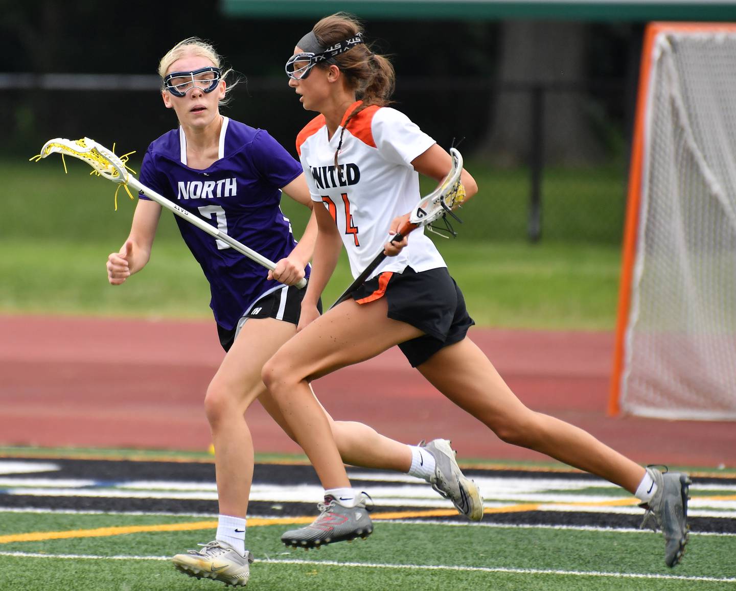 Crystal Lake’s Addie Bechler (right) races with the ball as Downers Grove North’s Barbara Schuessler defends during the Benet Supersectional game on June 3, 2025 at College of DuPage in Glen Ellyn.