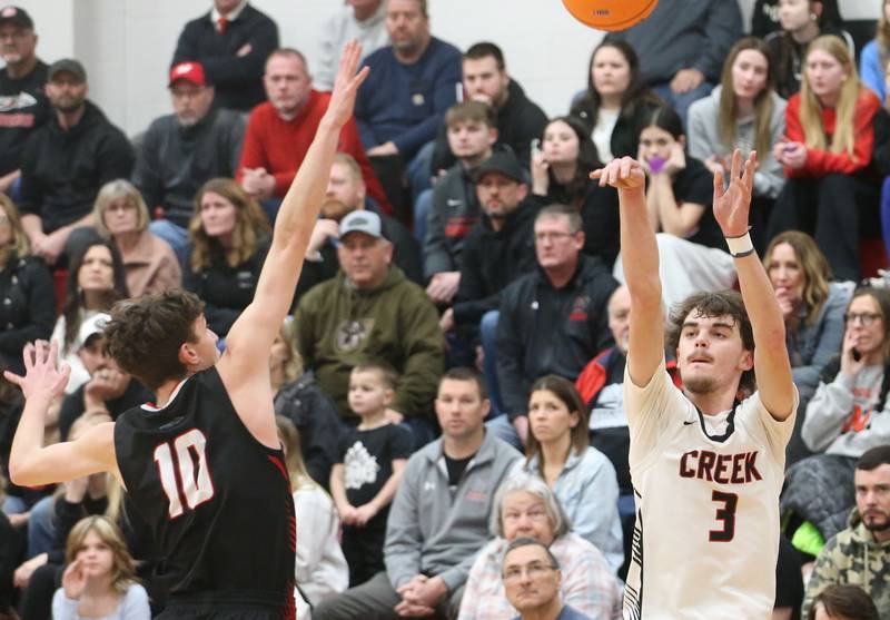 Indian Creek's Logan Schrader lets go of a wide-open shot over Woodland's Jaron Follmer during the Class 1A Sectional Semifinal game on Wednesday, March 4, 2026 at Amboy High School.
