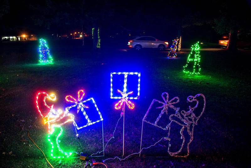 Elves toss a gift back and forth at one of the lighted scenes in Centennial Park in Rock Falls. The Coloma Park District is hosting the drive through lighted display for families get into seasonable spirit. The lights will be on until Christmas.