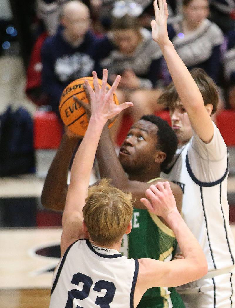 St. Bede's Yannis Yong eyes the hoop as Ridgeview's Carter Beck and Michael Dietsch during the Route 17 Classic Tournament on Wednesday, Nov. 27, 2024 at Woodland High School.
