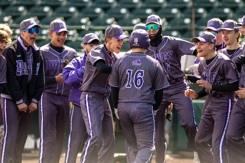 Dixon's Brady Lawrence (16) is met at the plate by teammates after hitting a homerun during baseball game between Dixon at Hampshire.  March 28, 2024