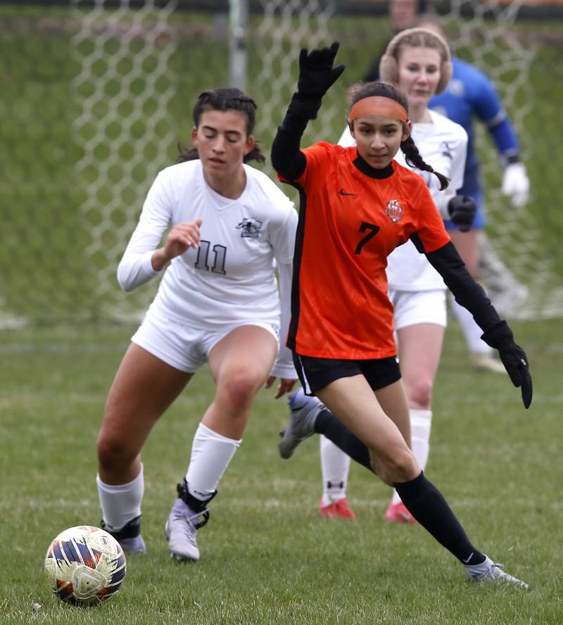 Kaneland's Corinne Faivre tries to knock Crystal Lake Central's Jenice Hernandez away as they chase down the ball during a nonconference soccer game on Thursday, April 10, 2025, at Crystal Lake Central High School.