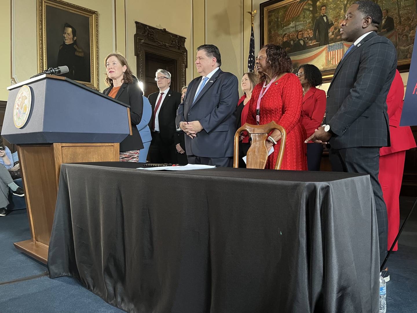 DCFS Director Heidi Mueller, left, speaks during a news conference Wednesday about the KIND Act.