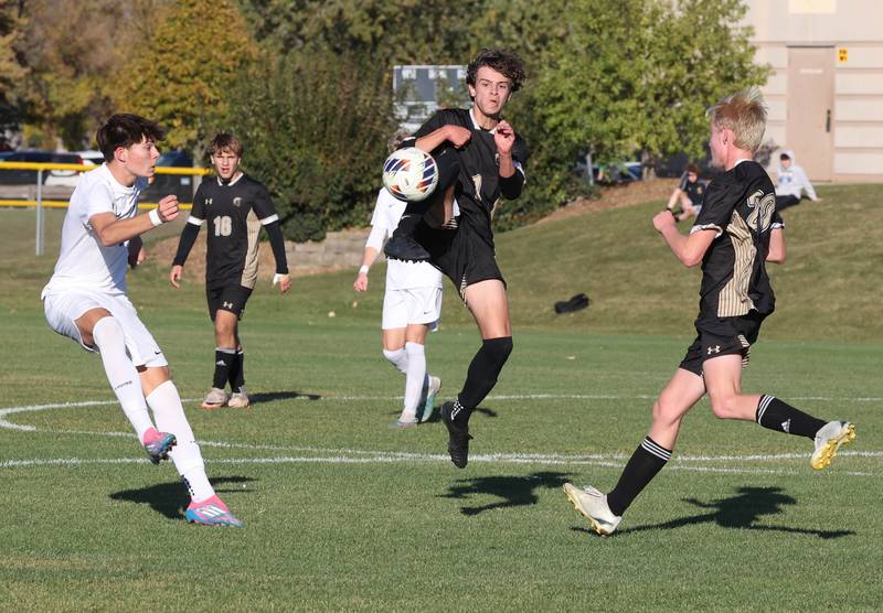 Sycamore's Noah Daykin kicks the ball between two players Wednesday, Oct. 23, 2024, during their Class 2A Sycamore Regional semifinal against Burlington Central.