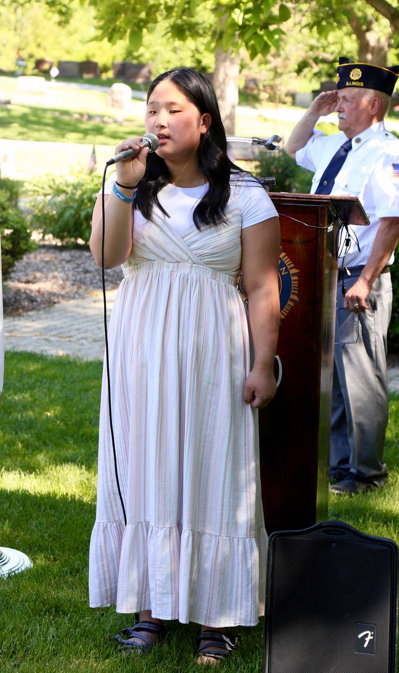 Aeryn Hwang sings the National Anthem at the Memorial Day ceremony on Monday, May 29, 2023 at Blackberry Township Cemetery in Elburn.