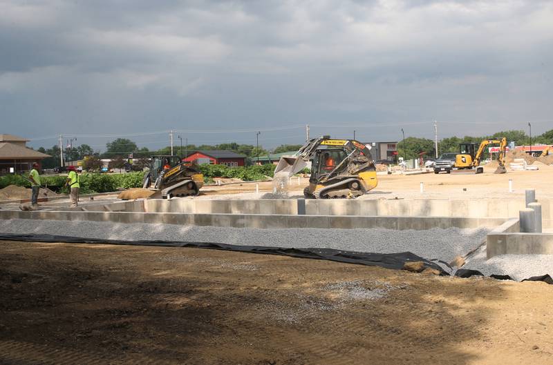 Crews move dirt near the intersection of Backbone Road and North Main Street on Tuesday, July 8, 2025 in Princeton. The foundation of a future Aldi store can be seen in the distance. Work started on the property beginning in April this year.