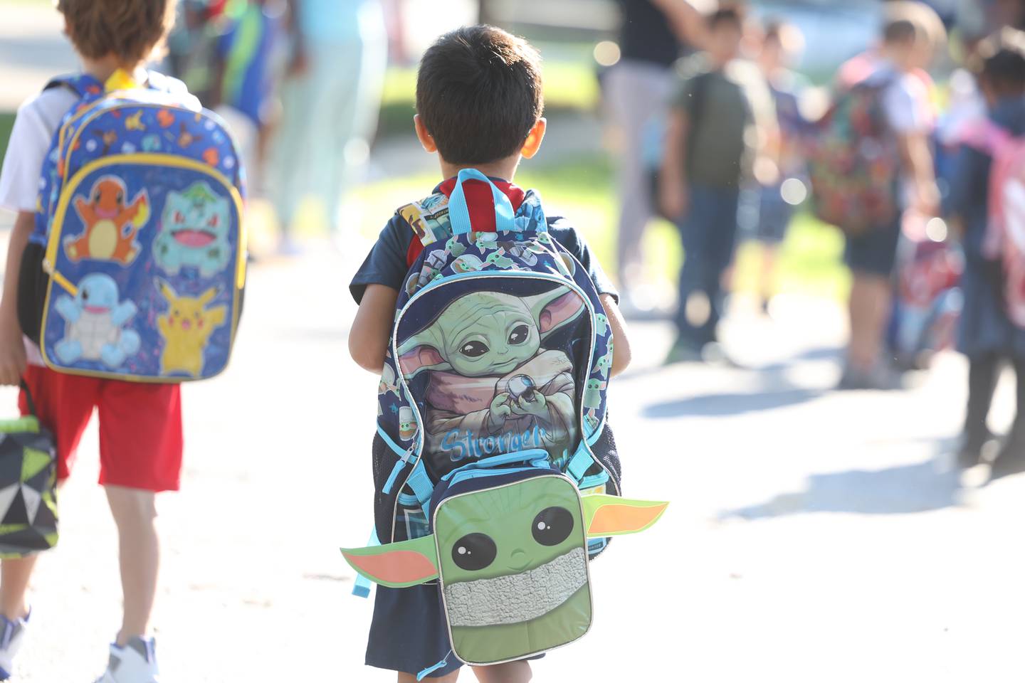 A student carries a themed backpack as he heads to class on the first day of school at Woodland Elementary School in Joliet. Wednesday, Aug. 17, 2022, in Joliet.