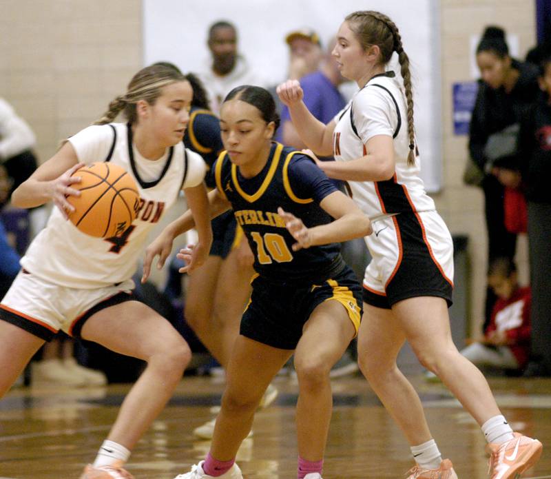 Nia Harris defends against Byron's  Macy Groharing. The Sterling Golden Warriors played  the Byron Tigers in the championship game of the Dixon Holiday Tournament at Dixon High School on Monday, December 29th, 2025.