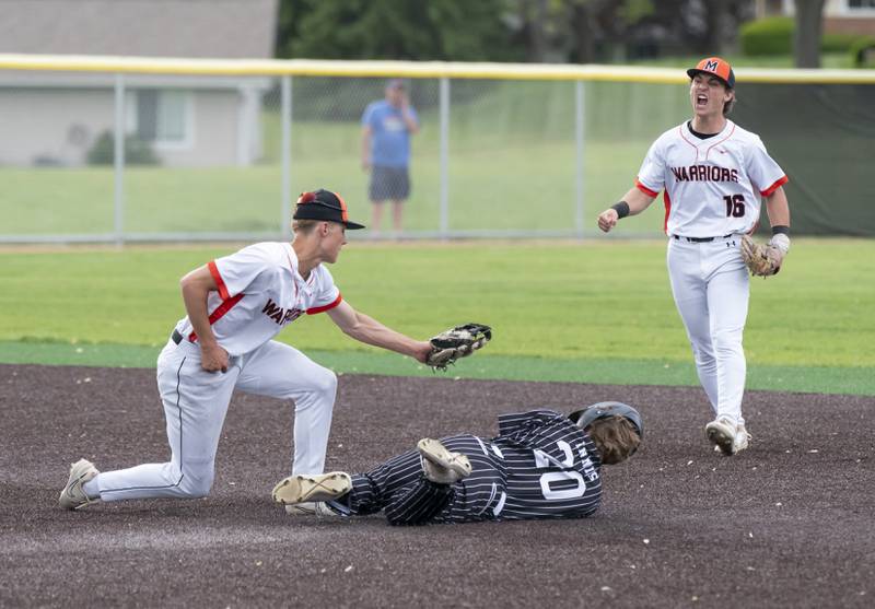 McHenry's Landon Clements tags Prairie Ridge's Connor Innis for the out at second base as McHenry's Kyle Maness cheers him on during their game on Friday, May 16, 2025 at McHenry High School. Ryan Rayburn for Shaw Local