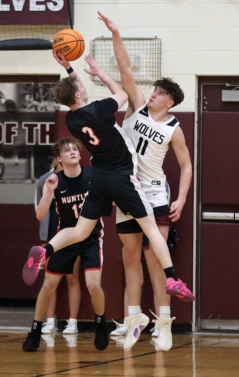 Huntley's Aidan Gibbs tries to shoot the ball over Prairie Ridge's Elijah Loeding during a Fox Valley Conference boys basketball game on Wednesday, Jan. 21, 2026, at Prairie Ridge High School in Crystal Lake.
