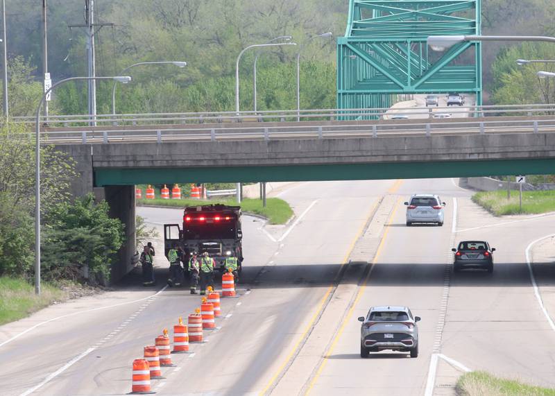 Peru firefighters work the scene of a tractor and tandem disk that leaked hydraulic fluid on the shoulder of Illinois Route 251 and 7th Street overpass on Monday, April 28, 2025. Peru Fire, Illinois Department of Transportation and Peru police responded to the incident.