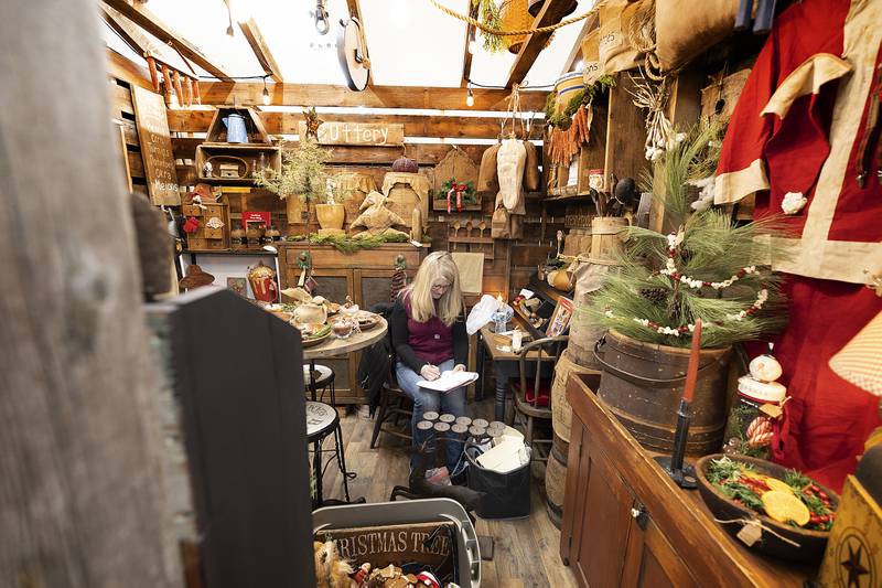 Cindy Kappes, a vendor at Waterfront Antiques, works on her sales Tuesday, Dec. 3, 2024. The antique and gift shop was booming for Shop Small Saturday.
