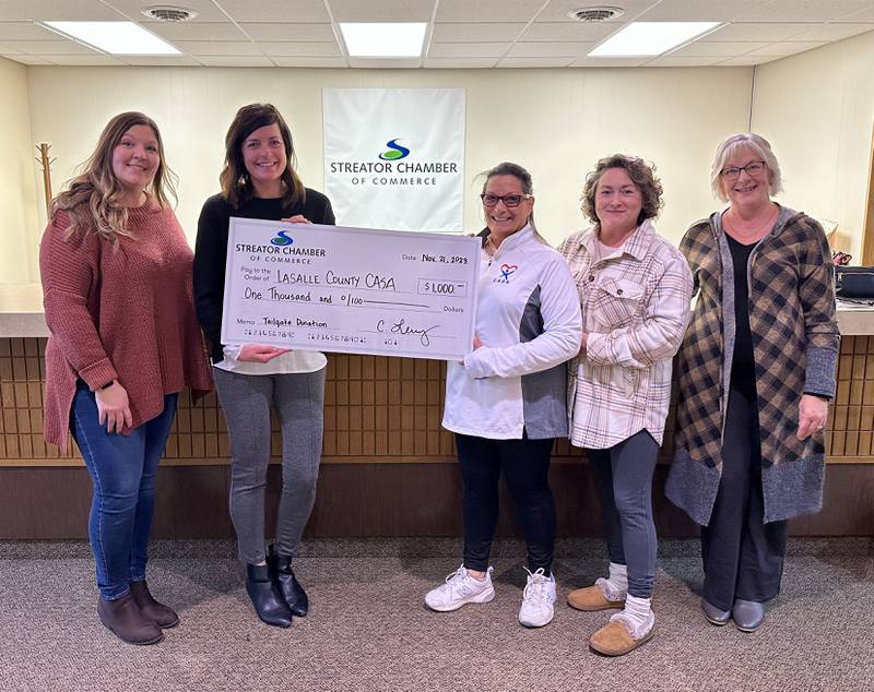 The Streator Chamber of Commerce presented La Salle County Court Appointed Special Advocates with a $1,000 check with proceeds from its Nov. 4 tailgate fundraiser.