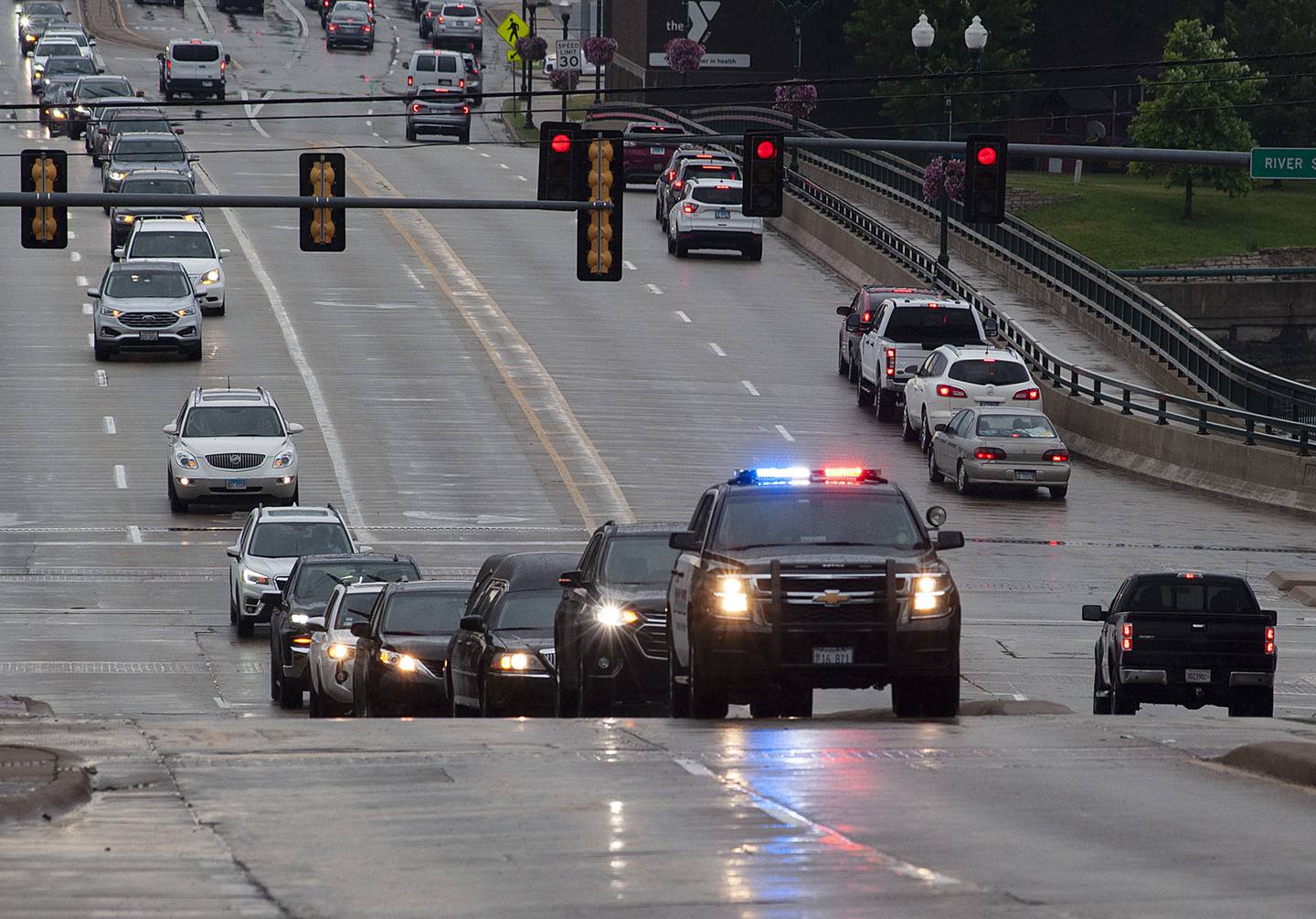 Mourners follow the procession of John Fritts as it makes it’s way to burial at Oakwood Cemetery Saturday, June 25, 2022.