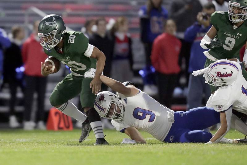 Bartlett's Dontain Williams (20) moves upfield past a Glenbard South player Friday September 23, 2022 in Bartlett.