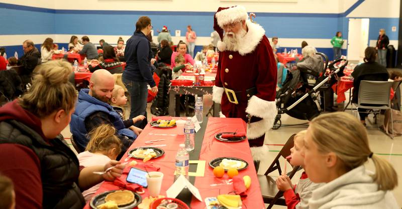 Santa Claus walks from table to table during a Breakfast with Santa hosted by the St. Charles Park District at the Pottawatomie Community Center on Monday, Dec. 12, 2022.