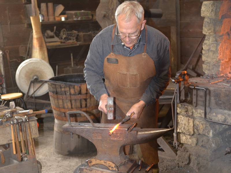 Greg Dutchoff works with hot steel in the John Deere Historic Site blacksmith shop Sunday in Grand Detour.