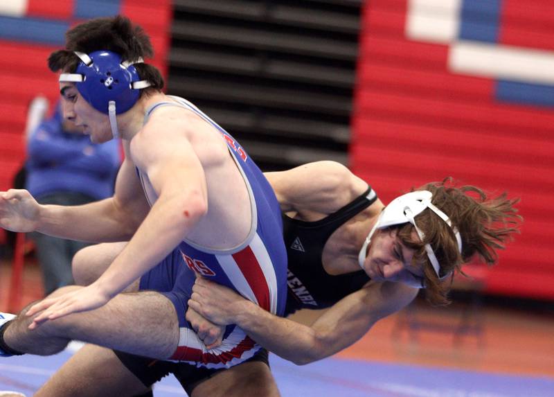 McHenry’s Jeff Schwab battles Dundee-Crown’s Jadon Wheatley in a 144-pound bout in varsity wrestling at Carpentersville Thursday night.