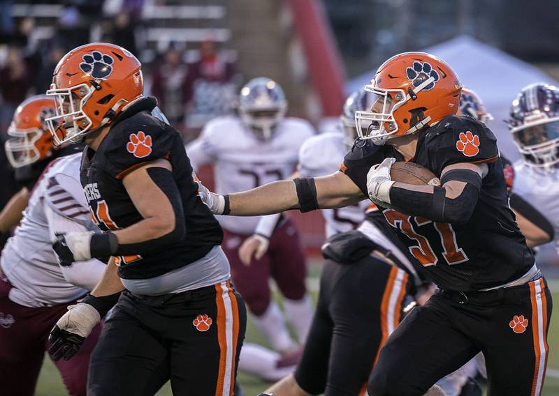 Byron’s Caden Considine follows his blocker against Tolono-Unity Friday, Nov. 28, 2025, in the Class 3A football finals at Hancock Stadium at ISU.