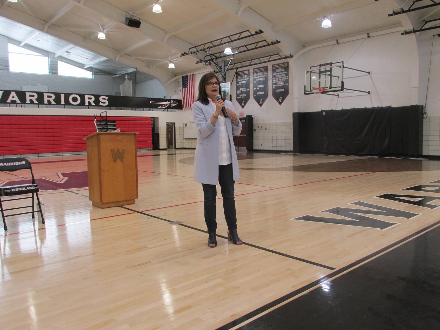 Woodland hall of fame inductee Jan (Appel) Holmes speaks to students Friday, April 14, 2023, during a presentation in the school's gymnasium.