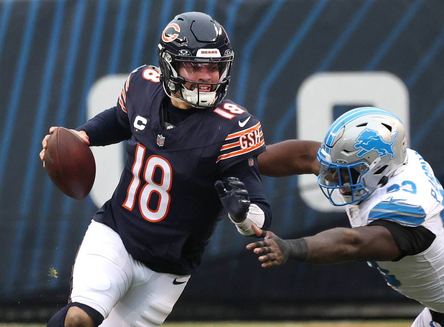 Chicago Bears quarterback Caleb Williams escapes the pressure of Detroit Lions defensive end Josh Paschal during their game Sunday, Dec. 22, 2024, at Soldier Field in Chicago.
