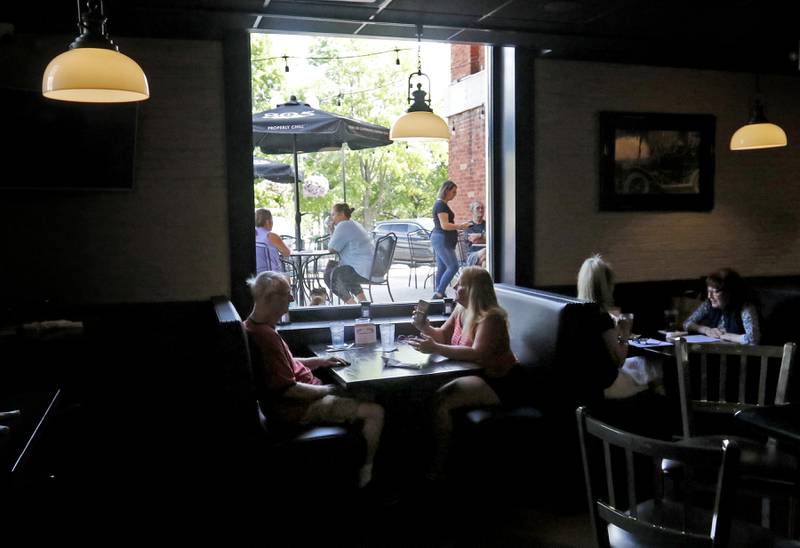 People dine inside and outside Tuesday, Aug. 29, 2023, at the Public House of Woodstock. The restaurant recently reopened after the newly remodeled Old Courthouse and Sheriff's House opened.
