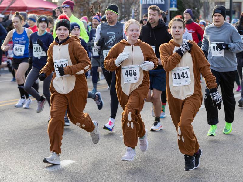 From left: Sydney Pelham, 13, Lily Mulder, 12, and Ariana Russo run the 13th annual Lions Charities Reindeer Run 5K Wheaton on Saturday, Dec. 7, 2024.