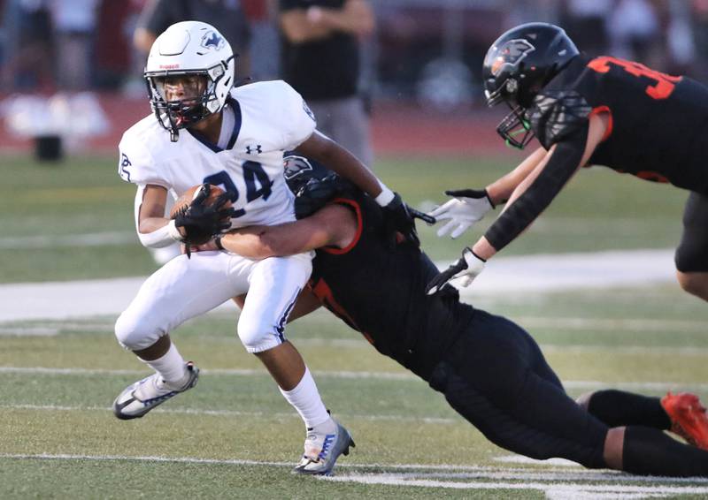 Plainfield South's Brooklyn Williams tries to pull away from a DeKalb defender during their game Friday, Sept. 1, 2023, at DeKalb High School.