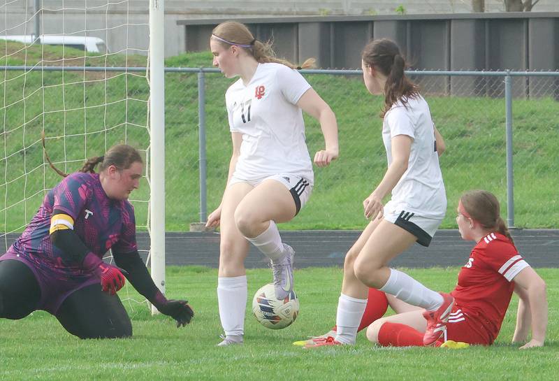 L-P keeper Lily Higgins reaches out to stop the ball with the help of teammates Avalyn Edwall and Amelia Buckley as Ottawa's Elle McGrath kicks the ball into the box on Monday, April 13, 2026 on King Field at Ottawa High School.