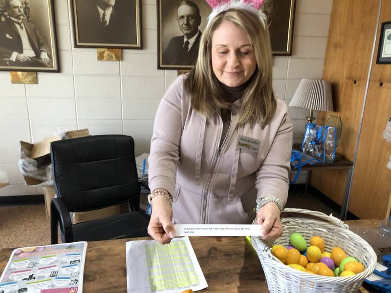 Karen Owens holds up a clue at the Huntley Area Chamber of Commerce scavenger hunt March 29, 2024.