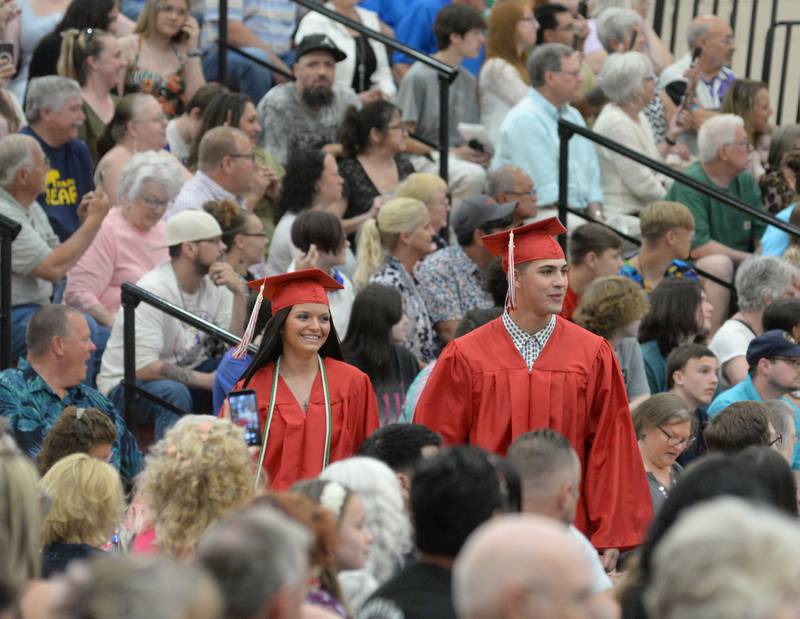 Seniors Katelyn Bowers and Anthony Bell walk into a packed Blackhawk Center for Oregon High School's commencement on Sunday, May 21.