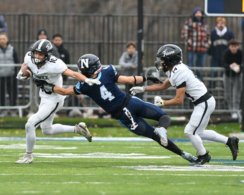 Fenwick's Will Tomczak (10) runs the ball while Nazareth Academy's Frankie Nichols (4) tries to tackle during the 6A semifinals game on Saturday Nov. 22, 2025, held at Nazareth Academy High School in La Grange Park.
